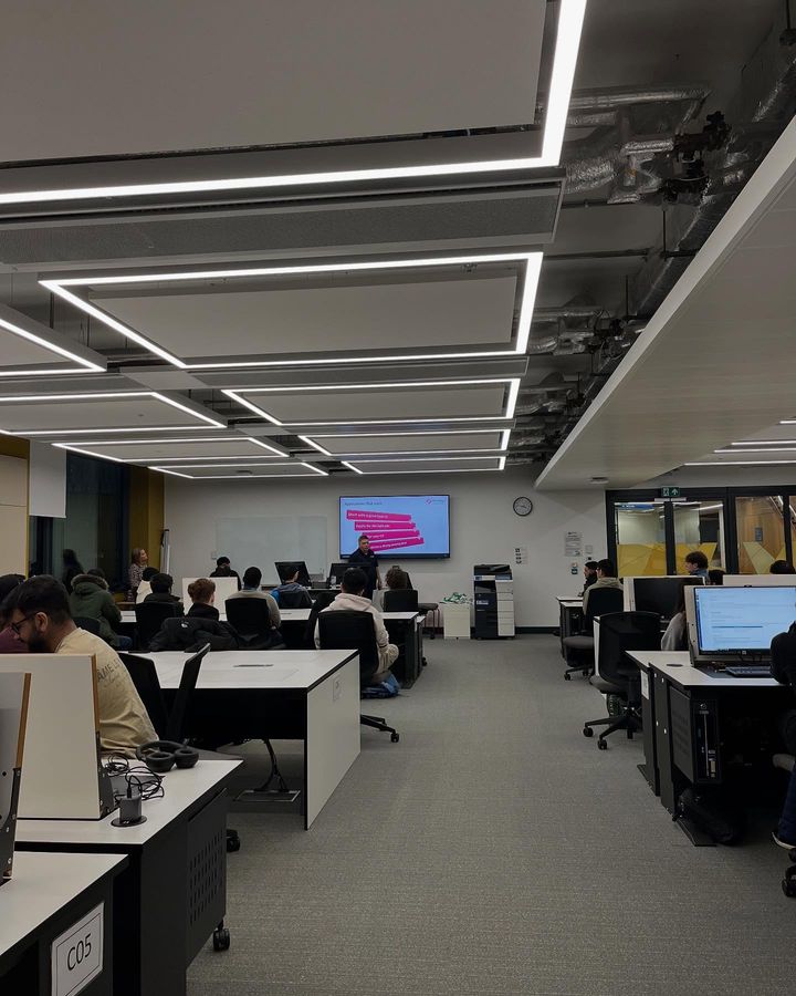A photo of a room with attendees working on computers.